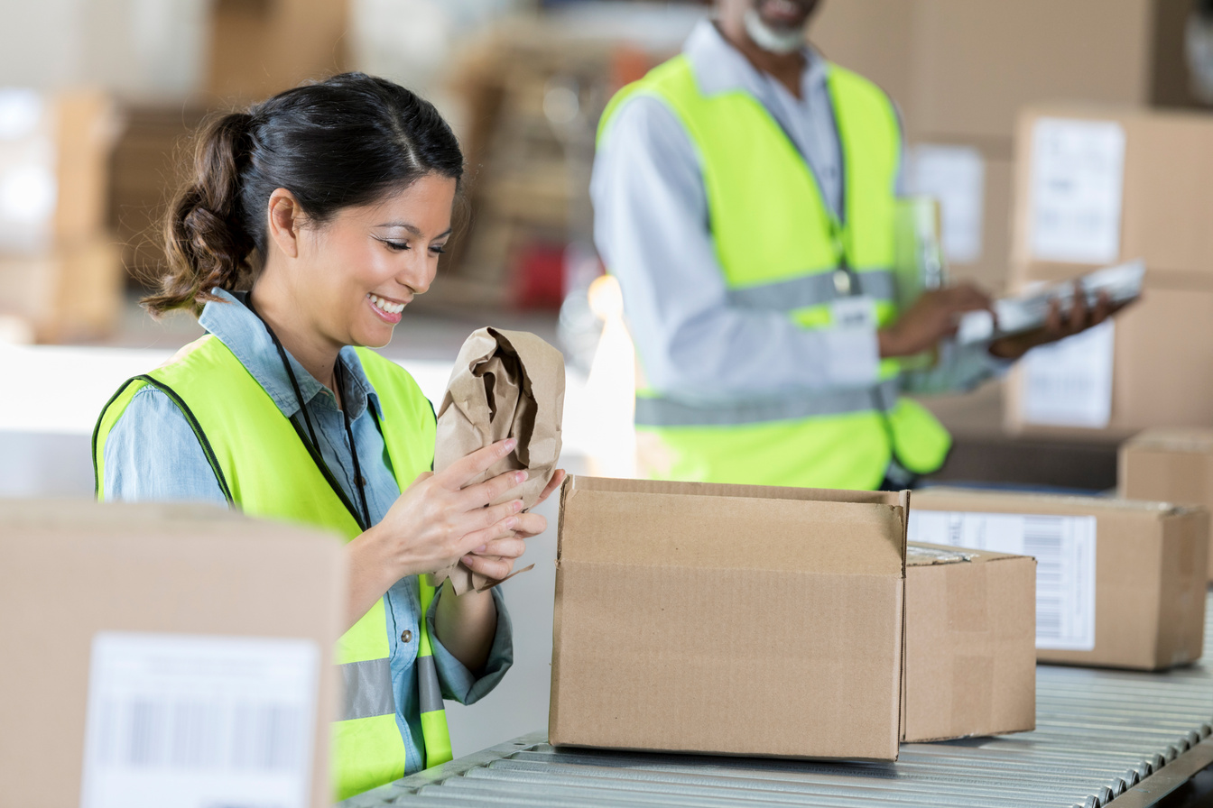 Distribution warehouse employee packs orders